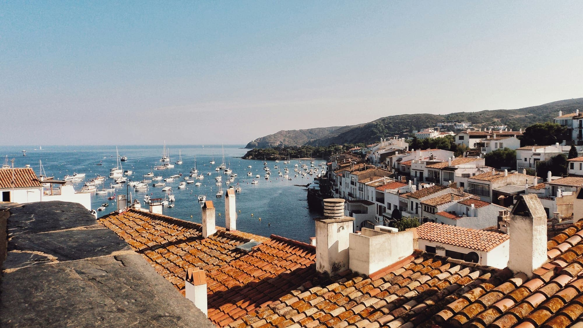 Whitewashed village and boats in a Costa Brava bay