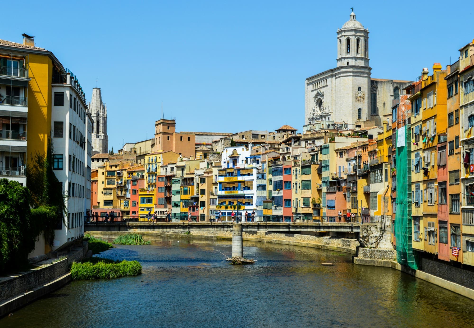 Colourful houses along the Onyar River in Girona, with the cathedral above